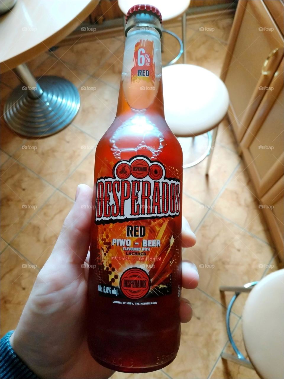 hand holding a bottle of desperados beer