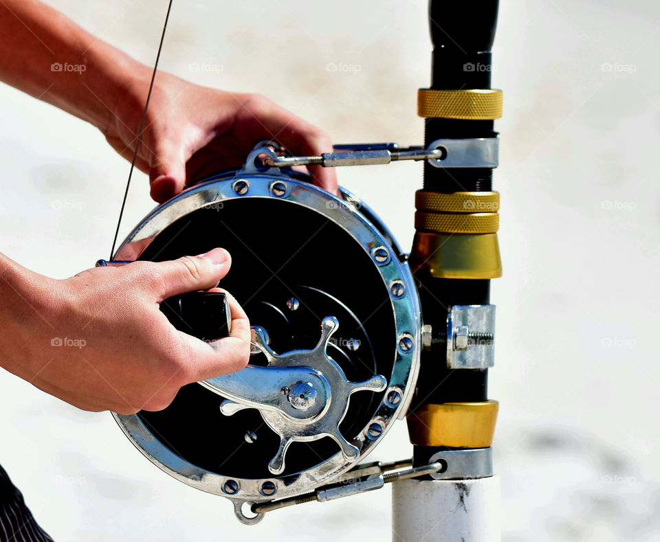 Close-up of a person holding fishing reel