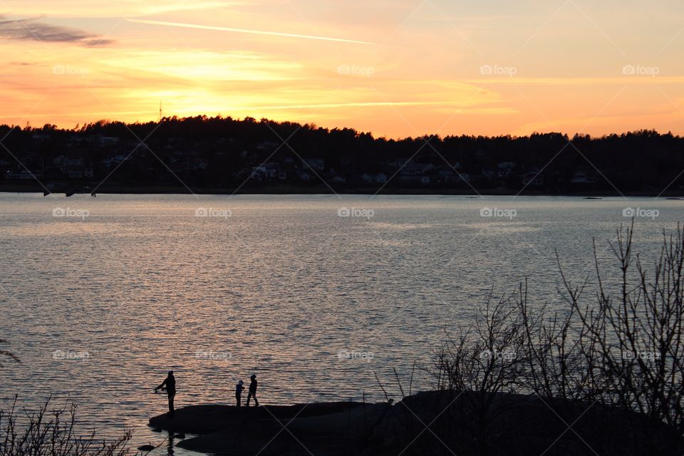 People fishing at rocky beach