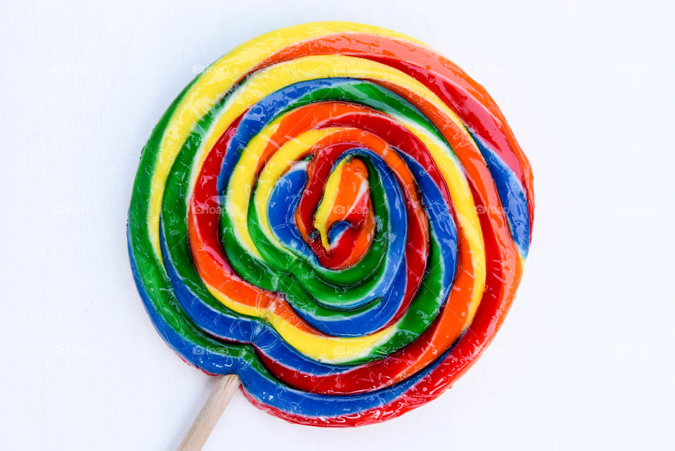 Close-up of a rainbow swirl colored lollipop