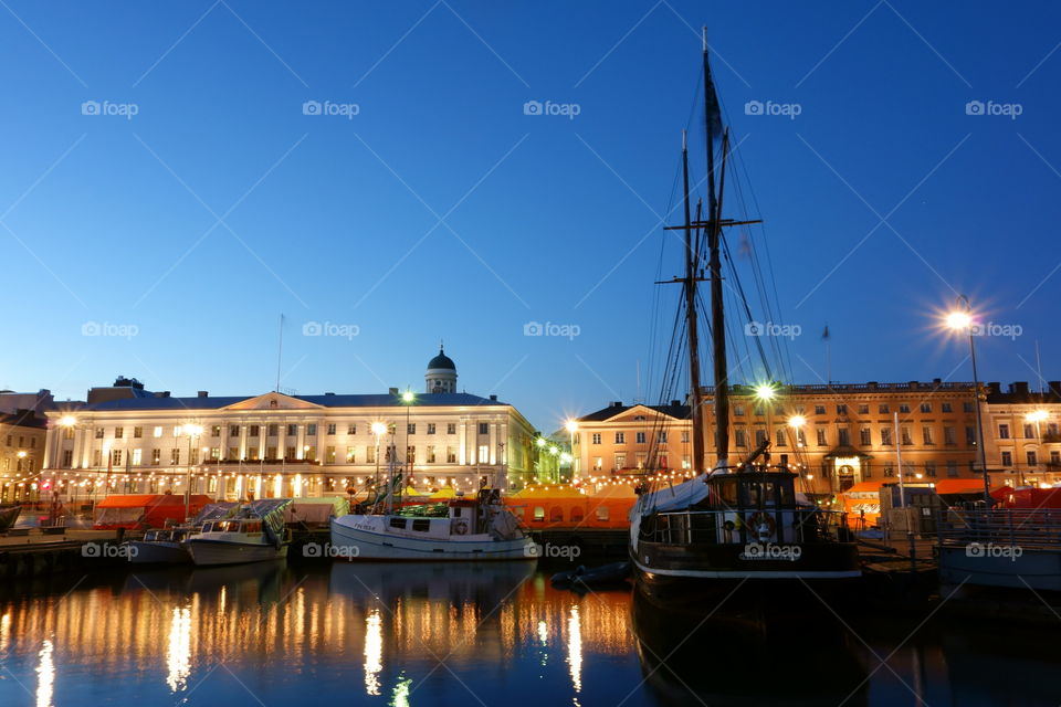 Fishing boats in the Market Square of Helsinki after sunset during the annual Helsinki Baltic Herring Fair  in October.
