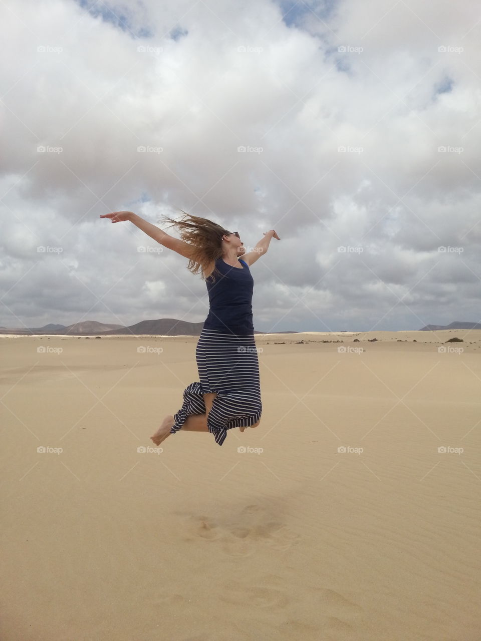 jumping over the dunes in corr. dunes in corralejo