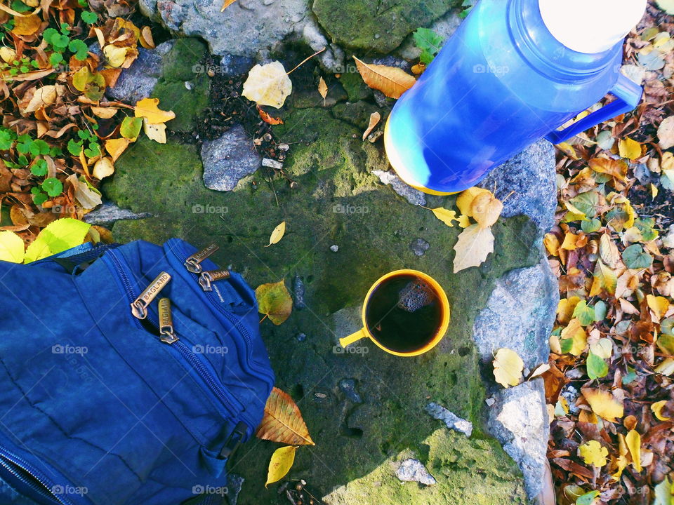 blue backpack, thermos and coffee cup