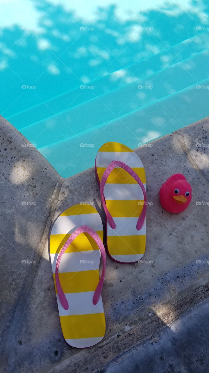 Flip flops and a pink duck