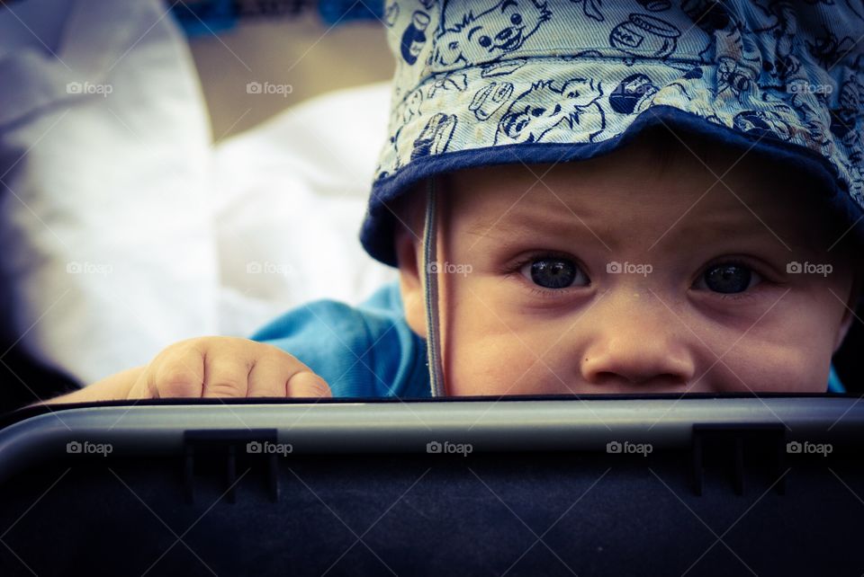 Cute baby. Baby sitting in a stroller