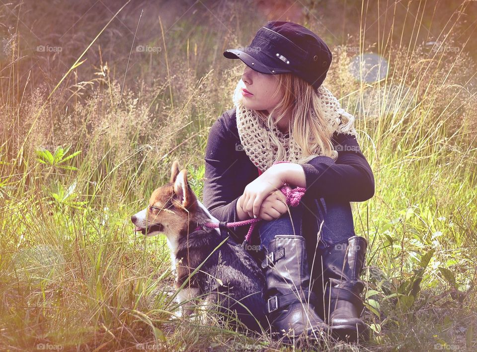 Girl and puppy. Girl sitting together with her puppy