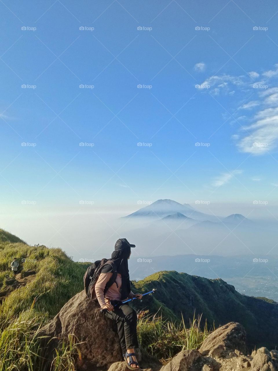 A woman is enjoying the mountain view in Semarang, Central Java, Indonesia.