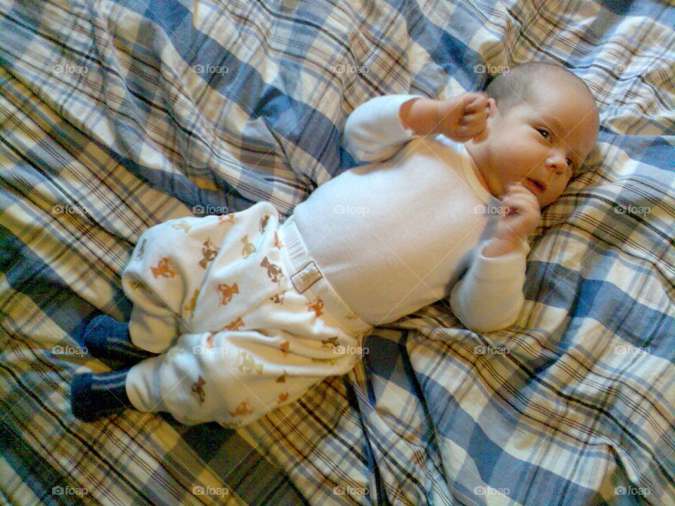 Newborn boy!. A little person lying in the bed and just looking cute!