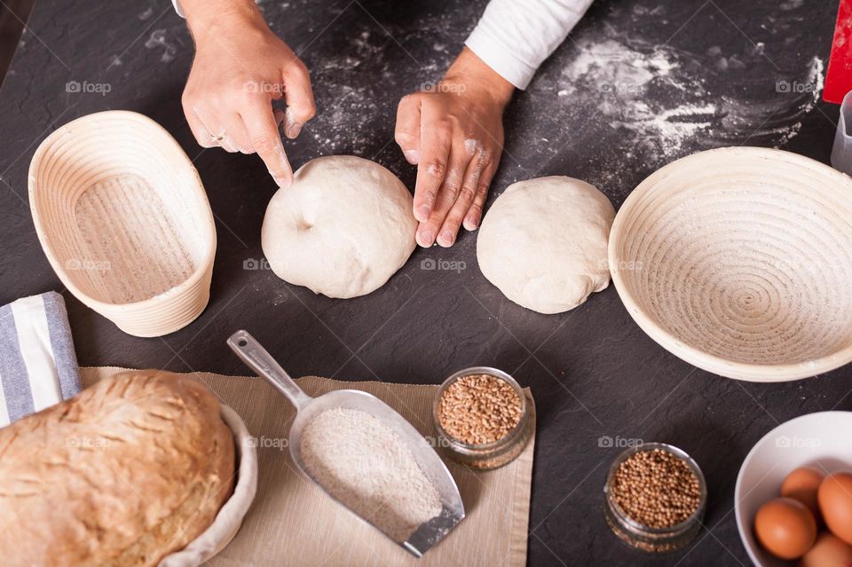 Checking springiness of dough. Folding and kneading dough for proofing and release air bubbles. Baking bread at home.