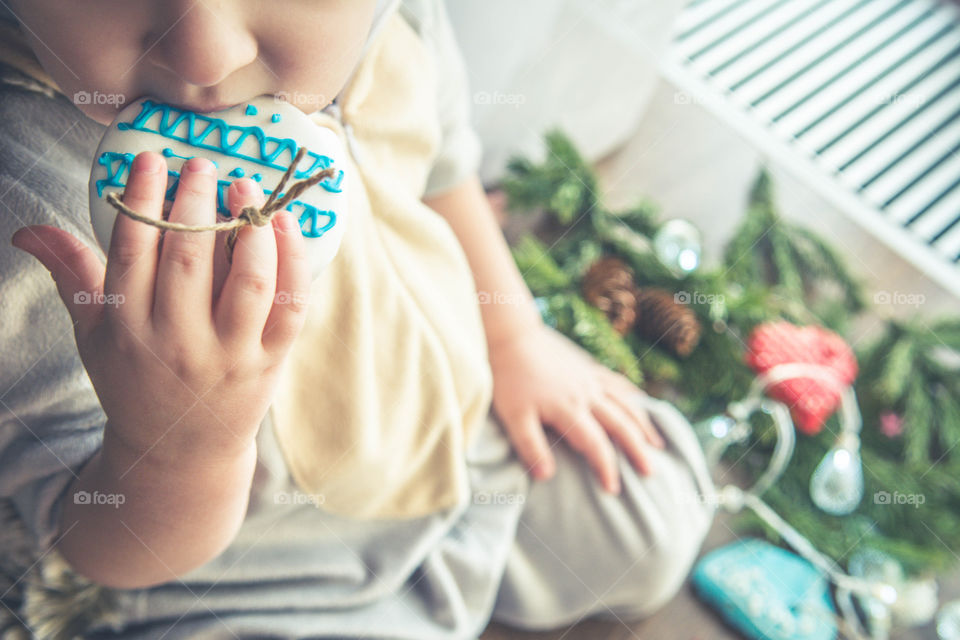 Little boy eating gingerbread