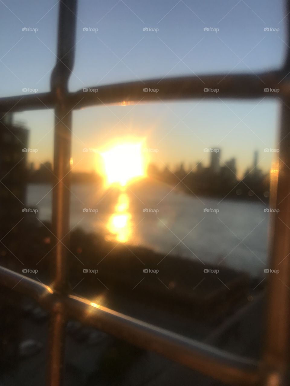 NYC skyline blurred through fence 