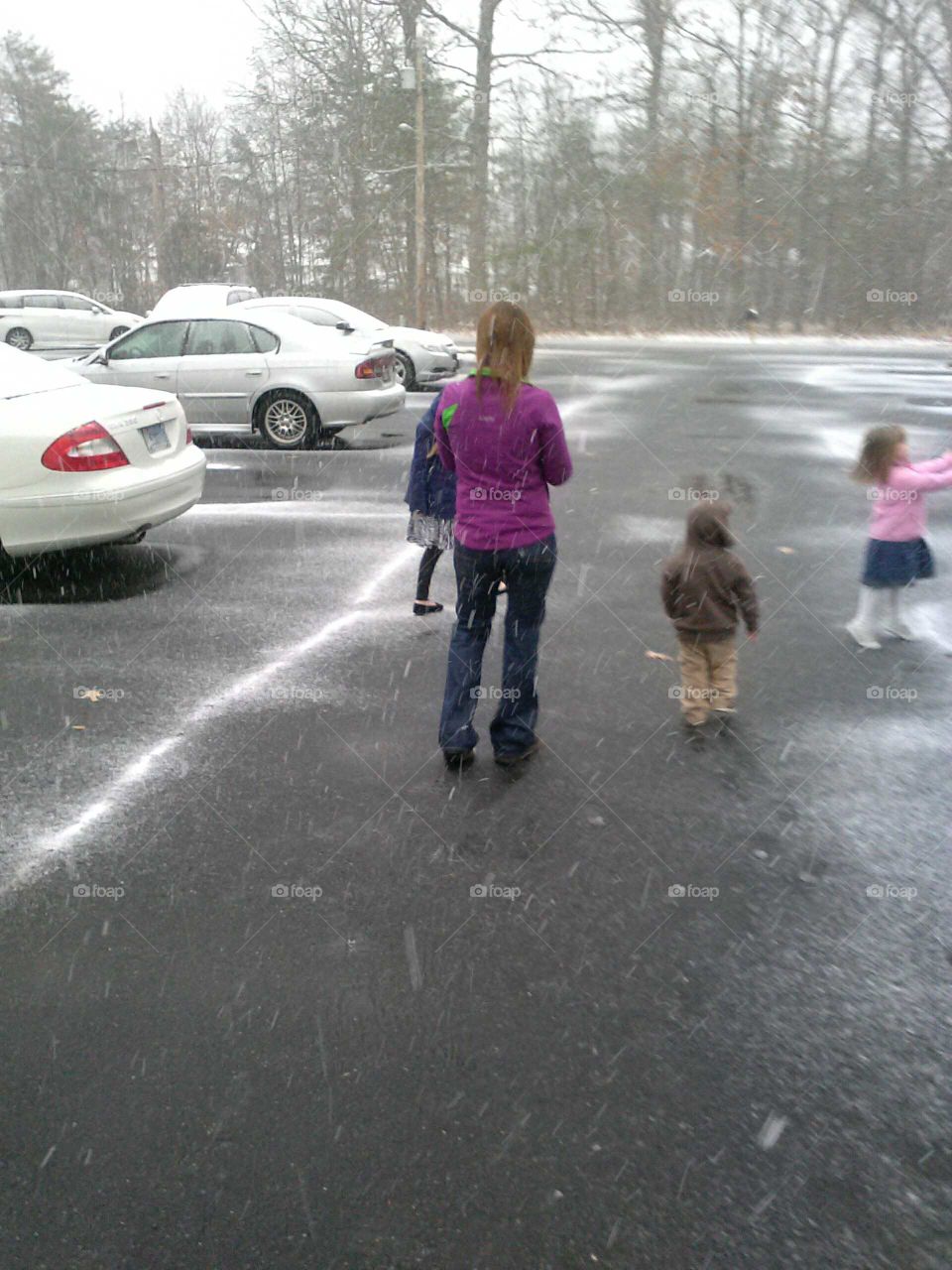 Mom and kids enjoy some surprise snow as they head into church.