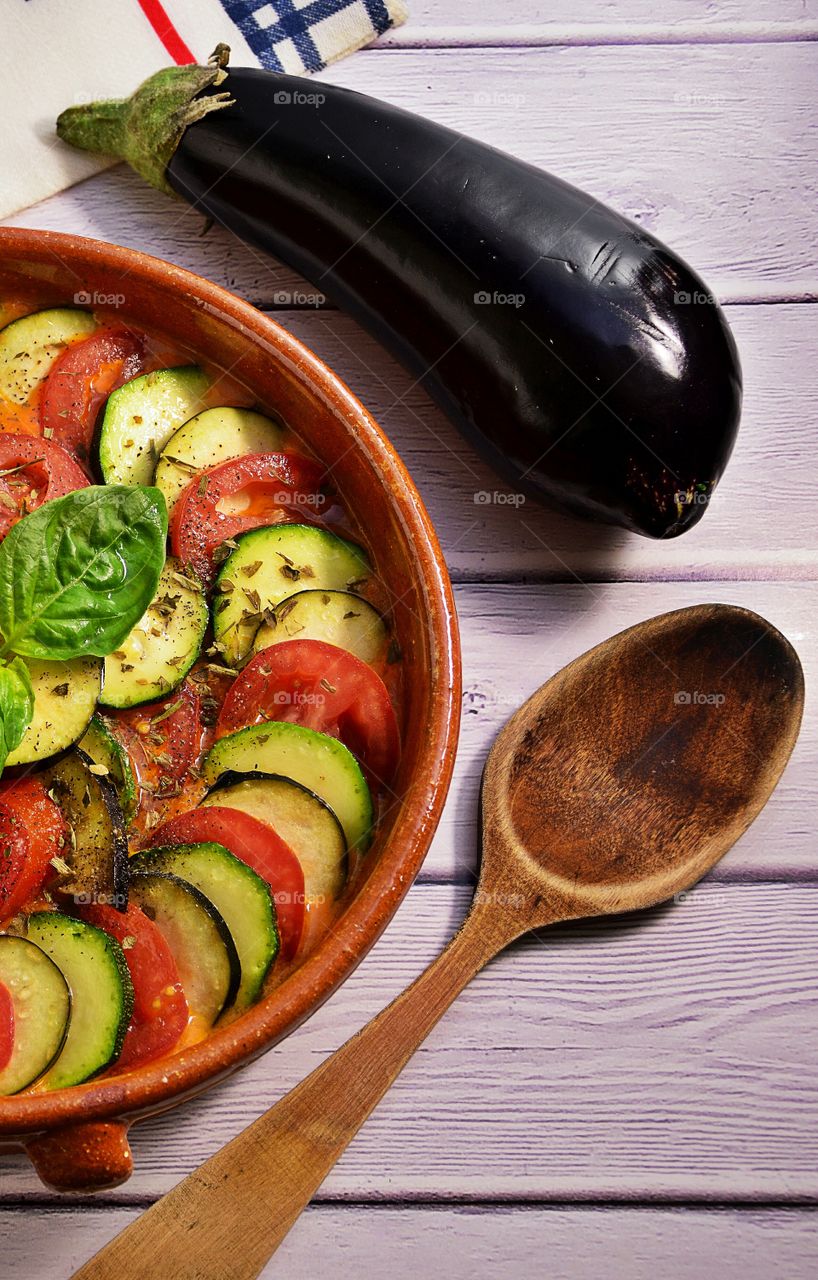 Sliced tomato and eggplant in cooking pot