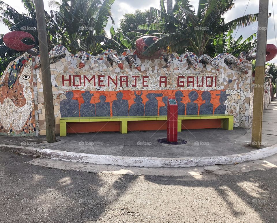 A welcoming sign-Homenaje a Gaudi (Homage to Gaudi), A mosaic tile wide bank created by José Fuster in the low-key district of the Jaimanitas, Cuba called Fusterlandia. 
