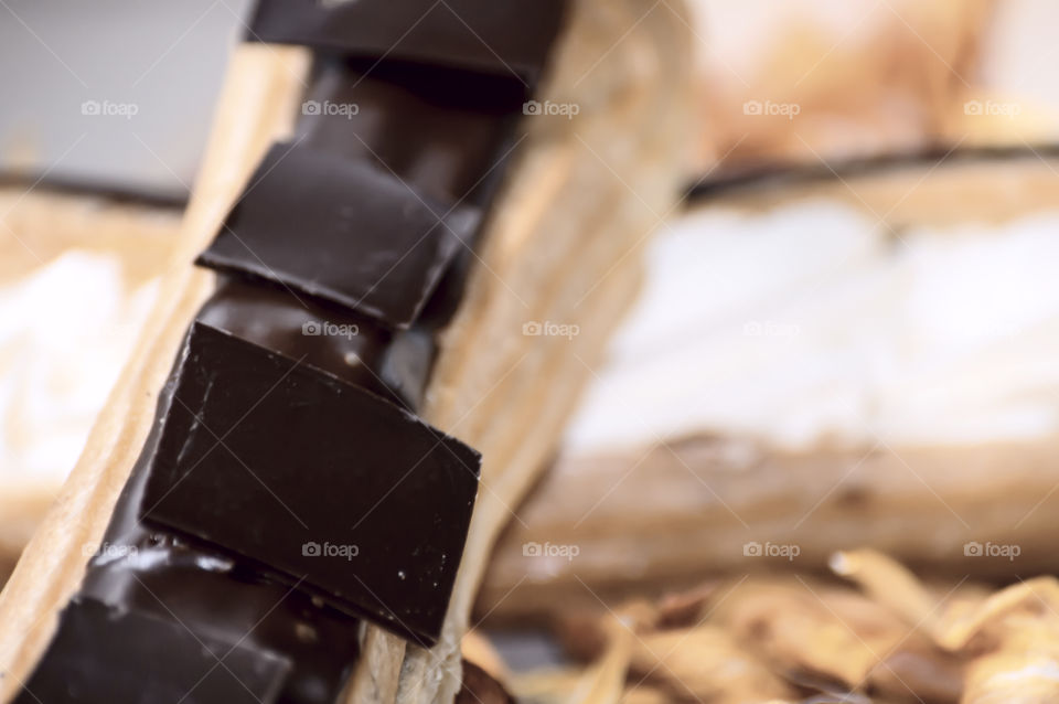 Chocolate pieces on Chocolate eclairs closeup decadent dark chocolate dessert photography 