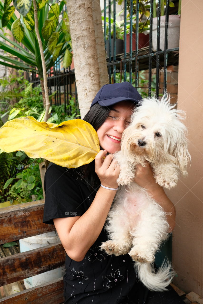 Happy woman with her pet a dog in hands