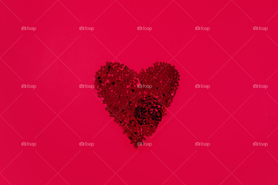 Glitter red heart. Cute symbol of Valentine's Day. Romantic concept. Love sign.  Flat lay background for cards,posters,banners,wedding desing invitation.Isolated on red background.