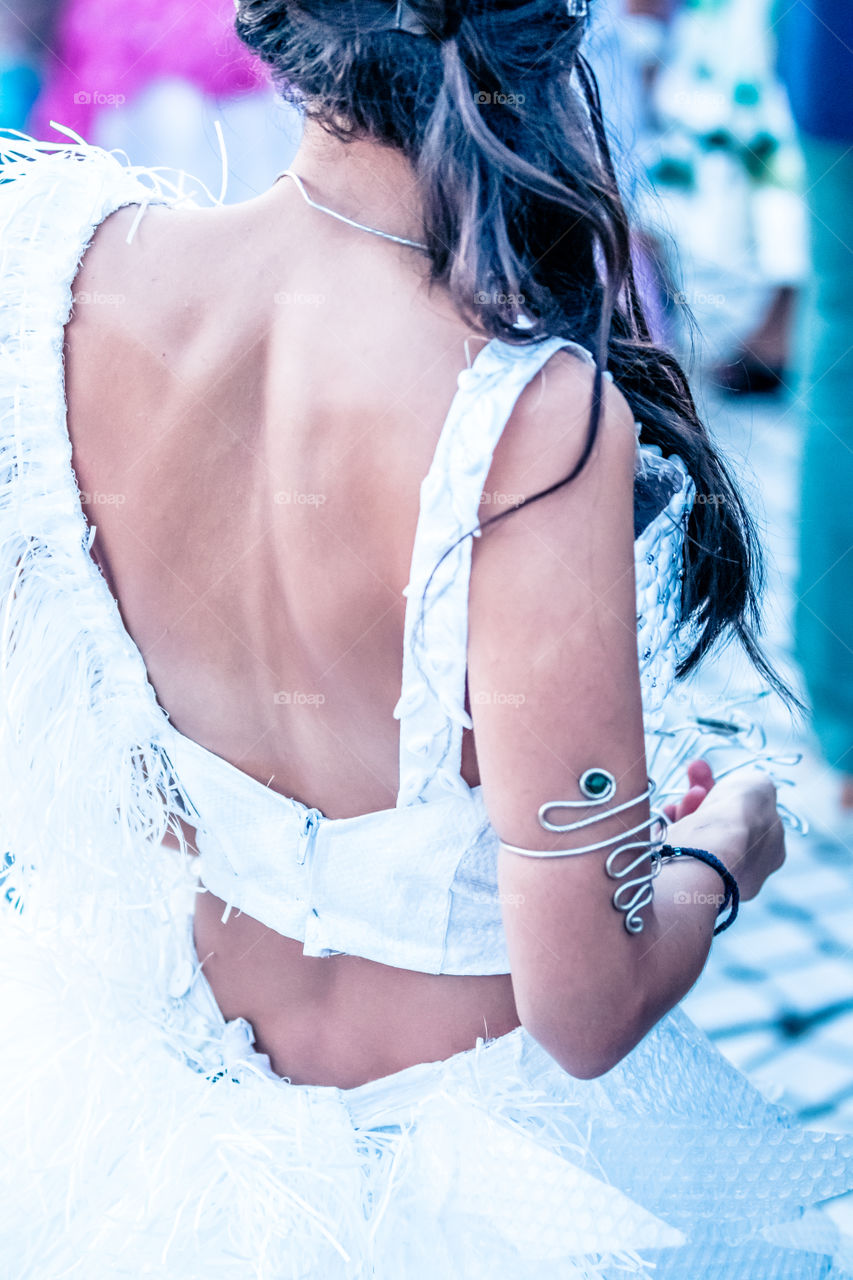 Back Side Portrait Of A Fashion Young Woman Wearing Evening White Dress