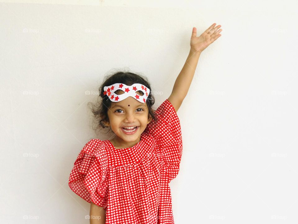 Hand made eye party mask on cute little girl.