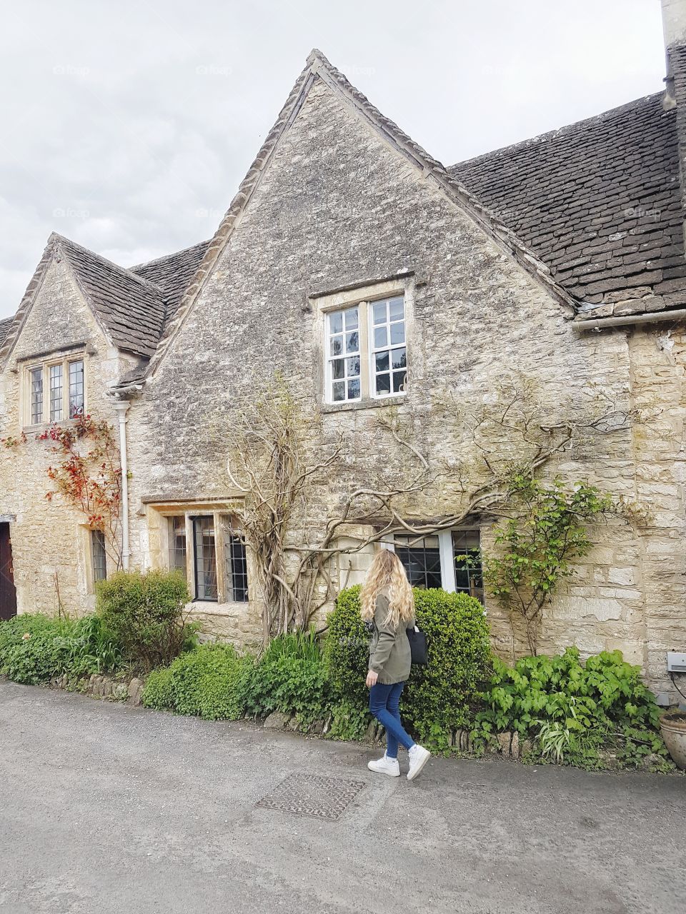 Girl walking  in castle combe ancient village