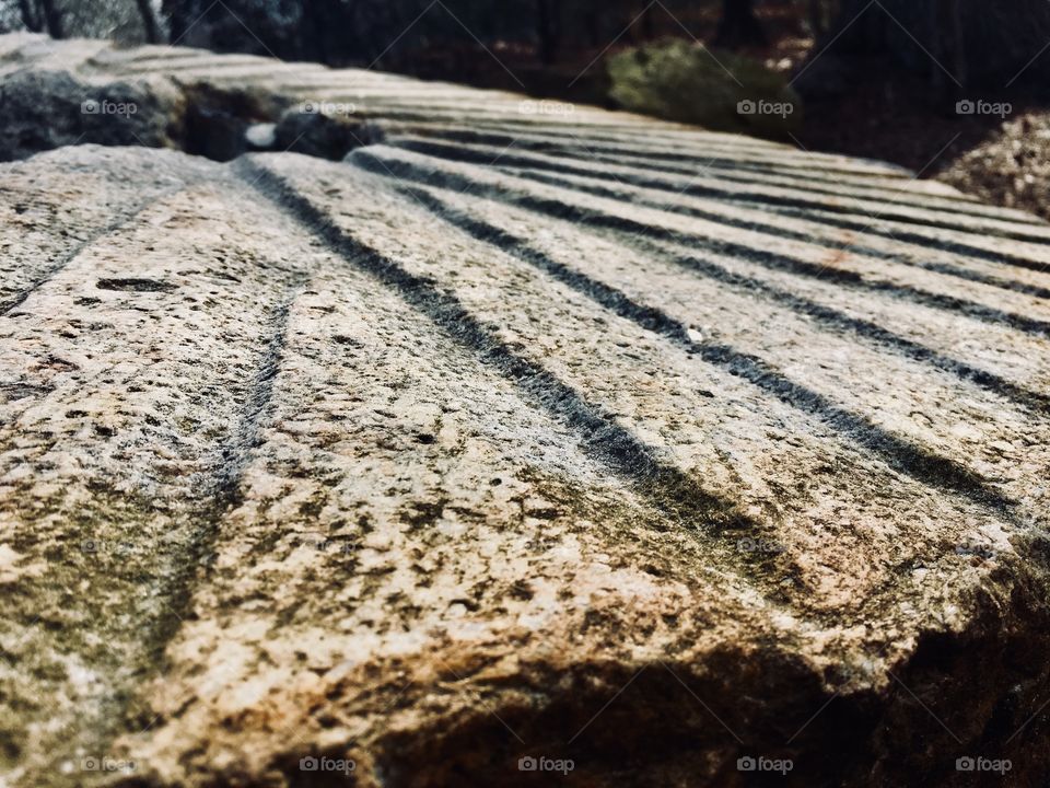 Closeup of a large grinding stone used to crush wheat and corn in an old gristmill many years ago 