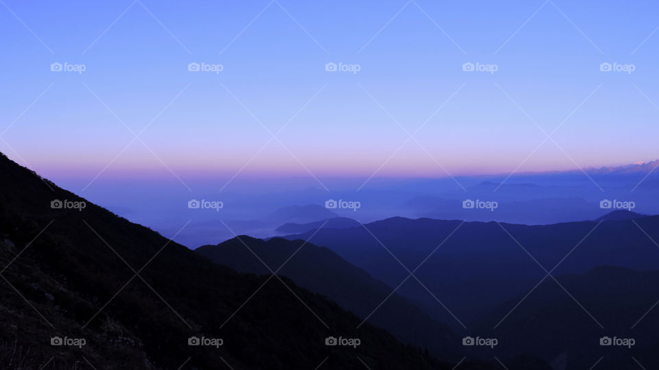 Scenic view of mountains at foggy weather