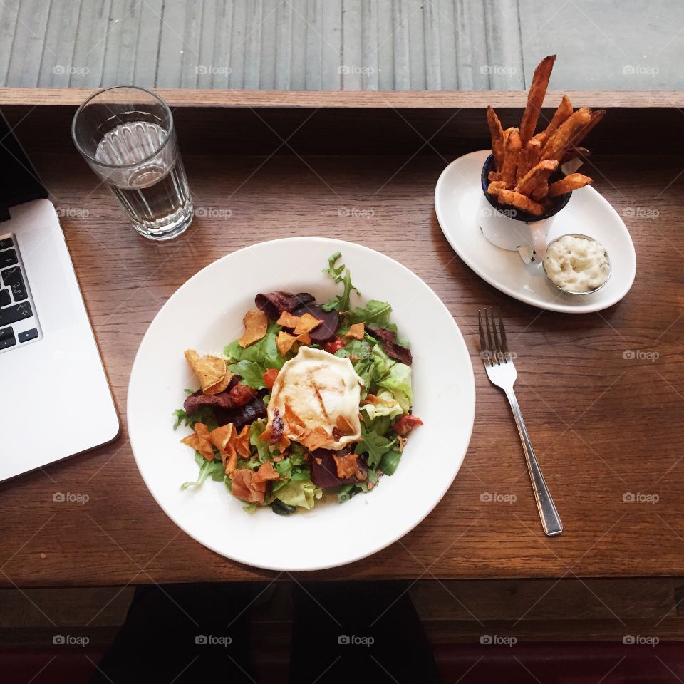 The meal. Goats cheese salad, side of sweet potato fries and laptop