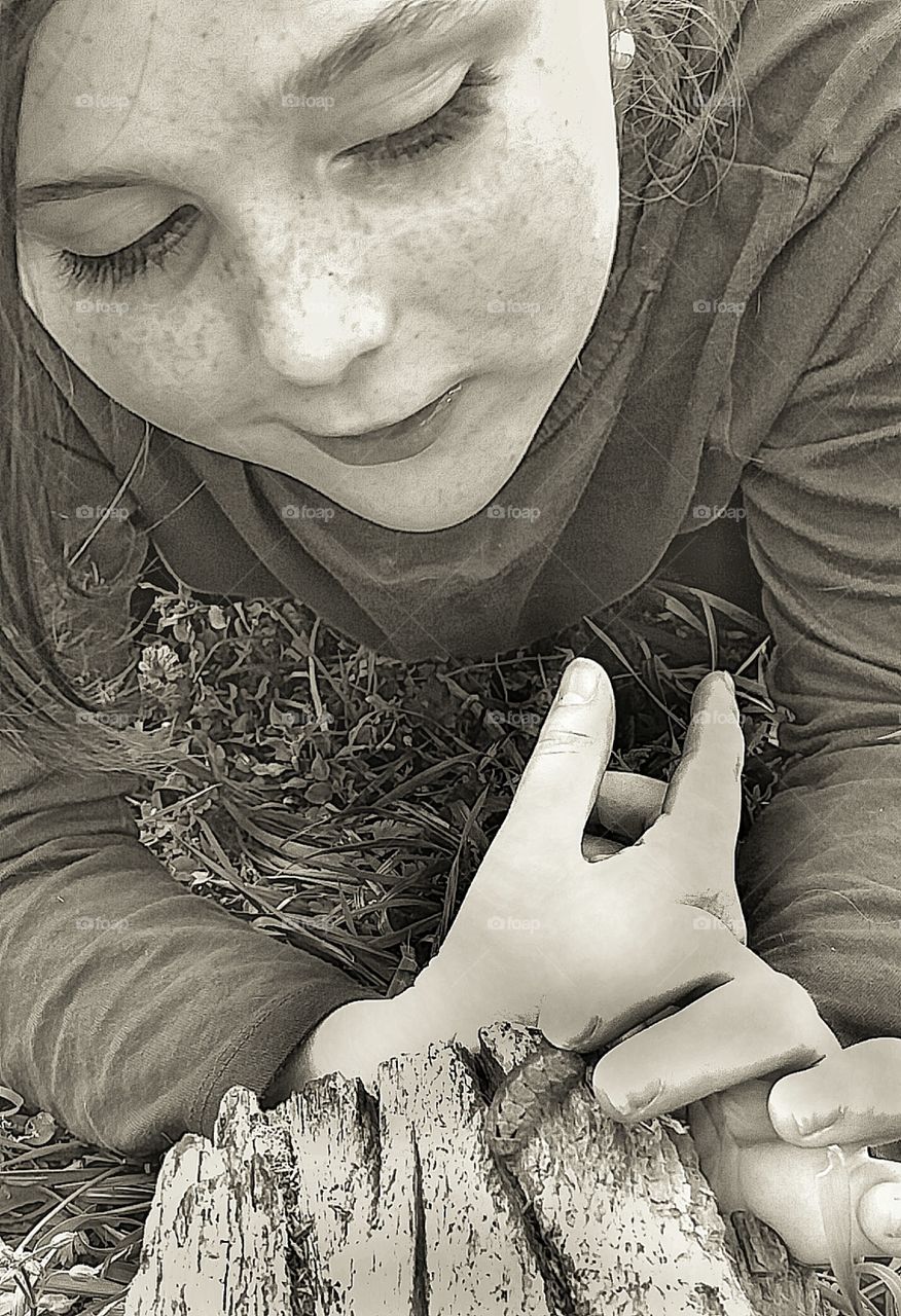 black and white girl touching worm