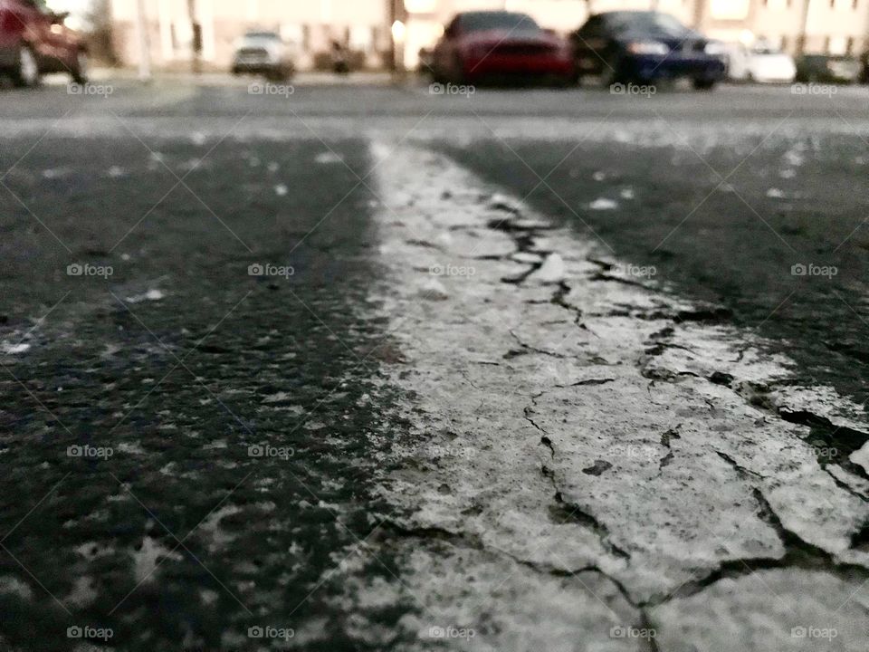 Painted street line surrounded by new fallen snow. 