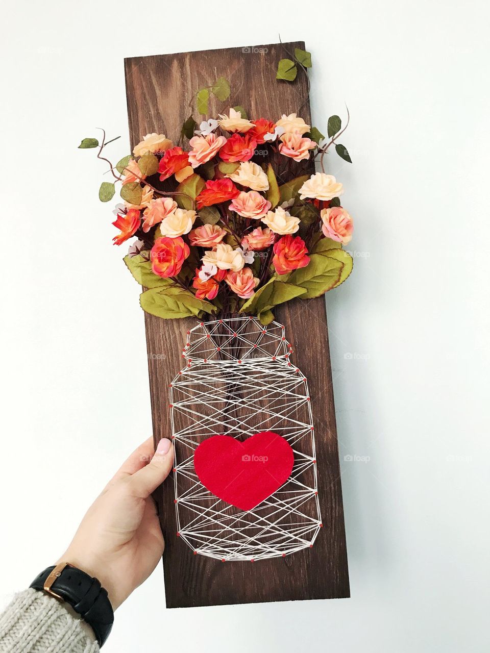 Handmade wooden wall art decor. Vase with flowers
