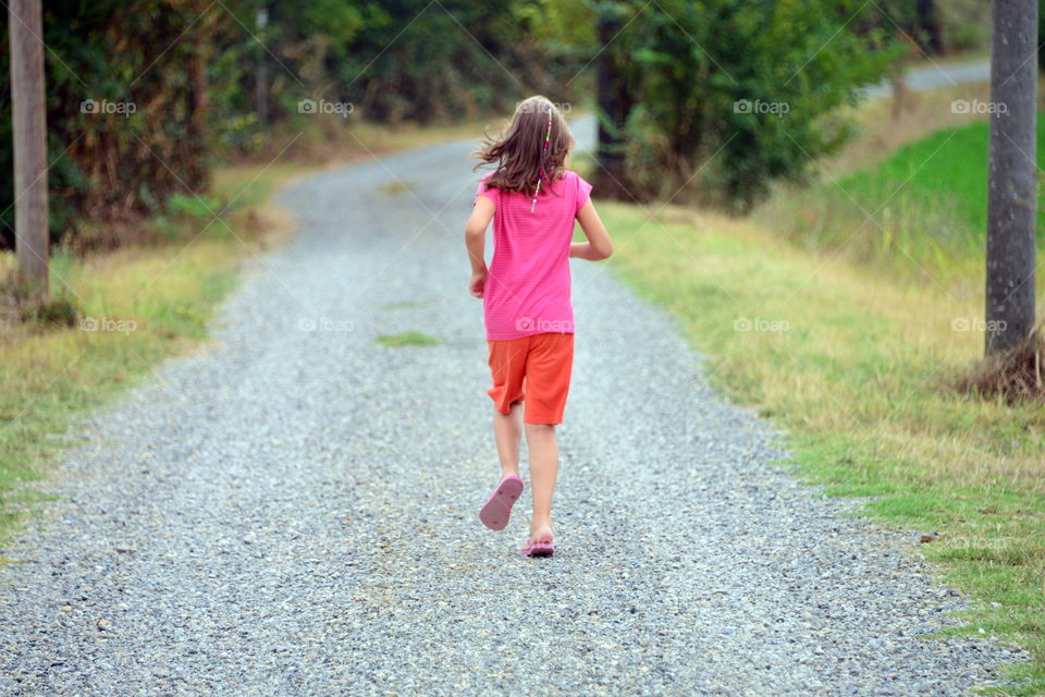 a little girl running in the park