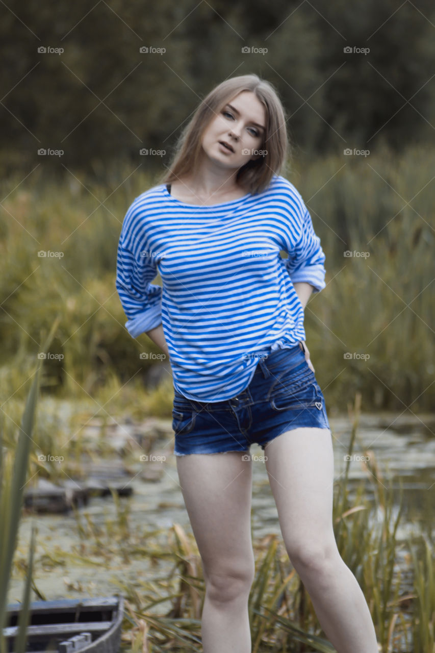 A girl with blond hair on the lake in a striped shirt and short denim shorts on the background of grass, reeds and an old wooden boat
Girl, woman, man, blonde, blonde hair, striped shirt, short shorts, denim shorts, shore, lake, grass, reeds, old boat, feelings, emotions, tenderness, love, lifestyle, lifestyle, vacation