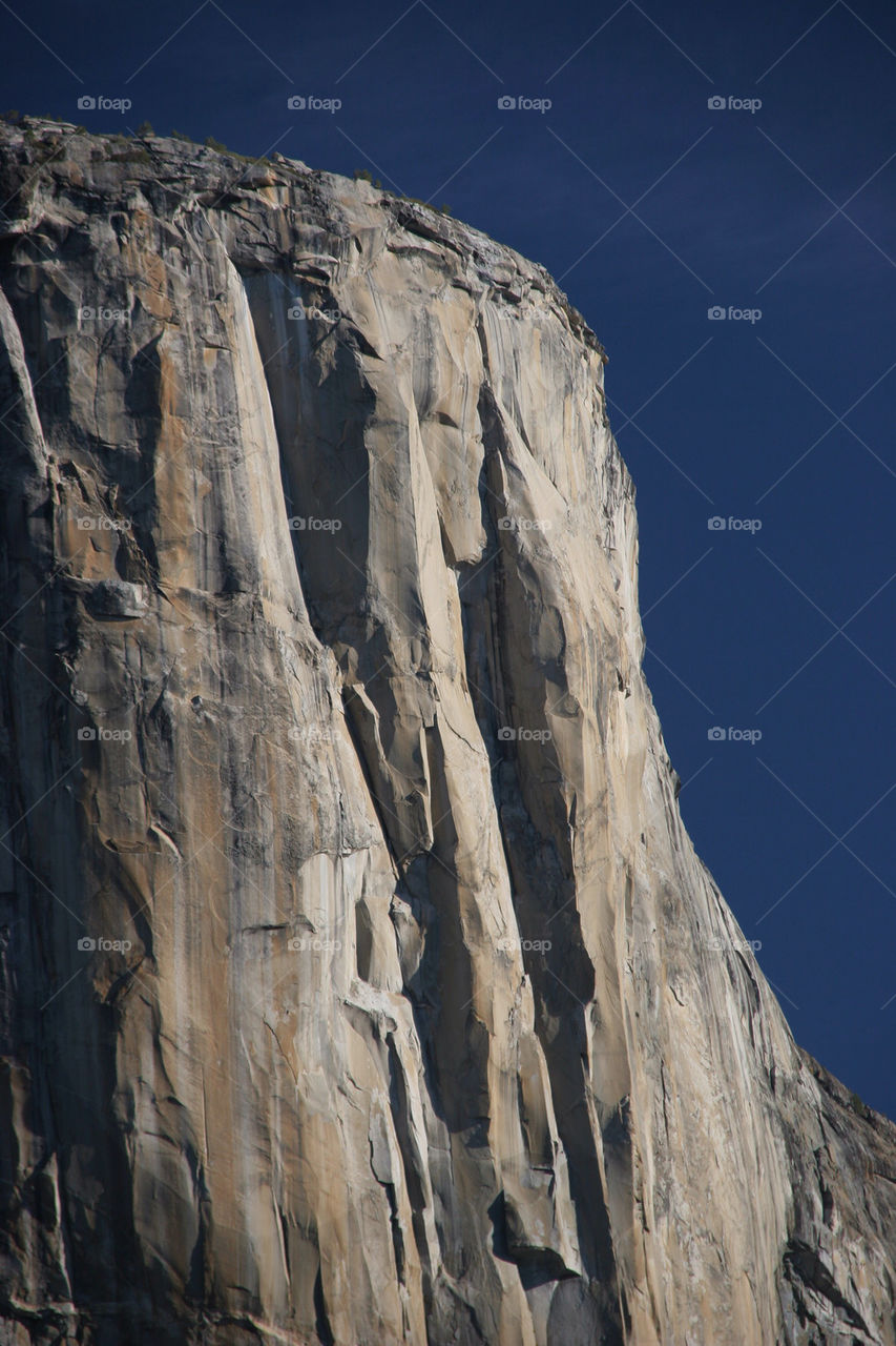 Scenic view of cliff against clear sky