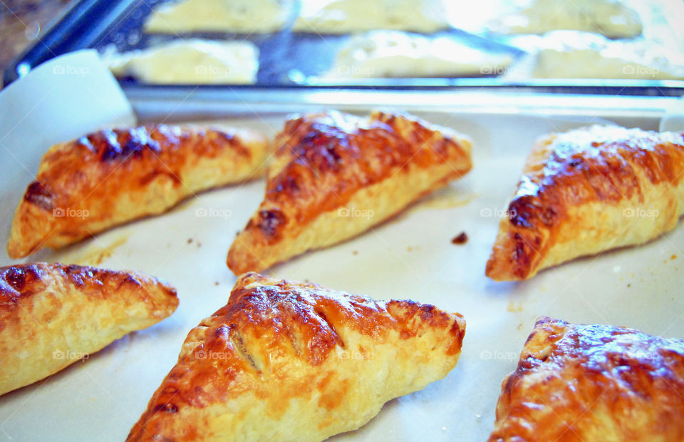 homemade glazed guava cheese strudel after baking, front focus, uncooked or prepared blurred at background before