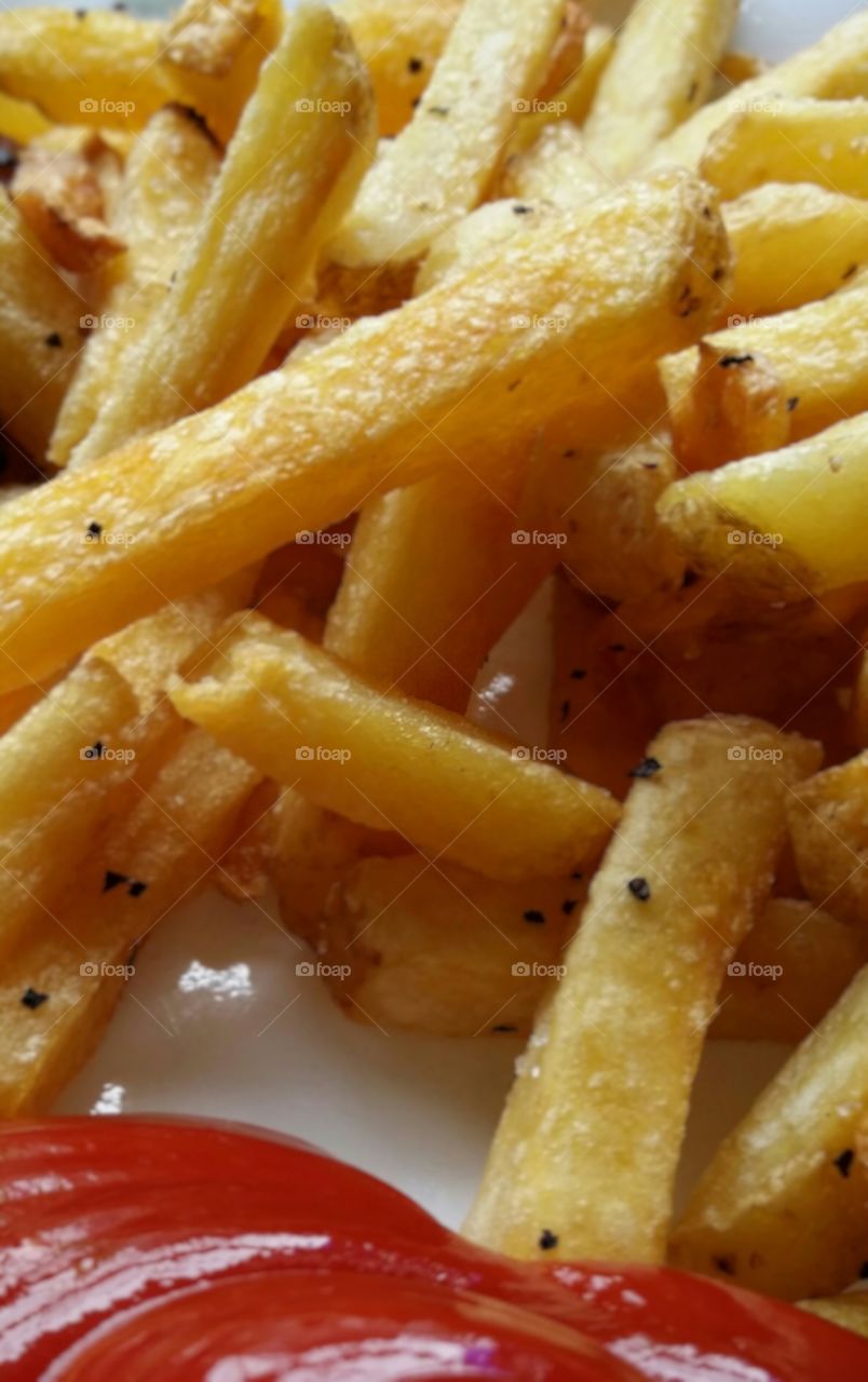 Golden french fries with ketchup