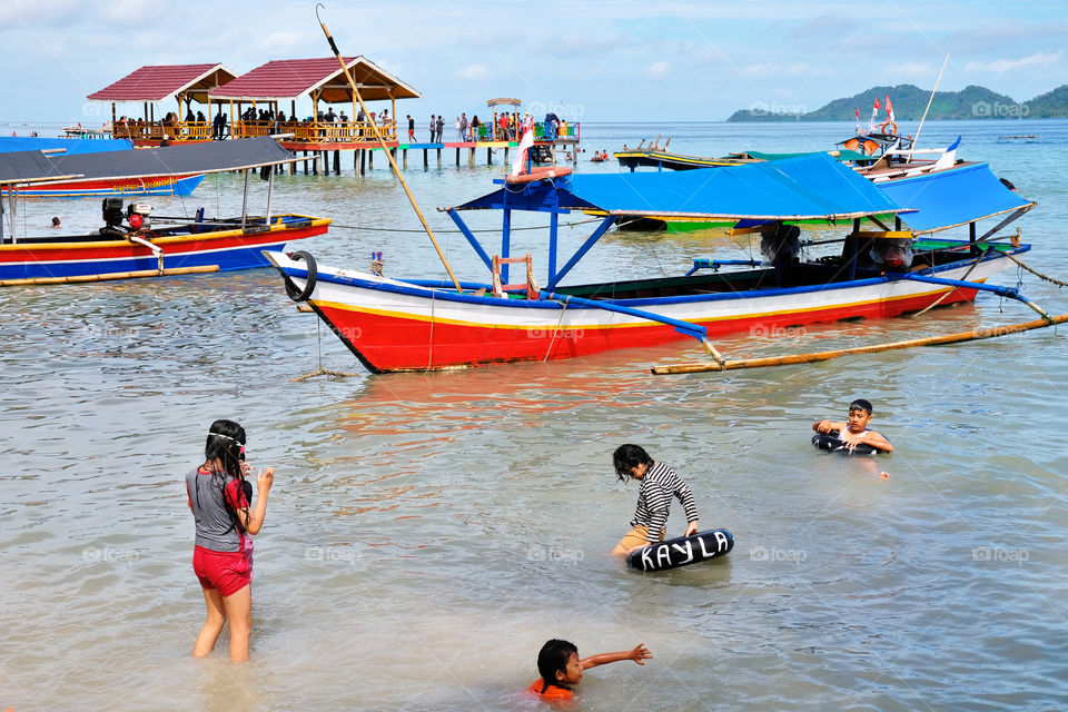 playing in the sea of Klara Beach, South Lampung, Indonesia