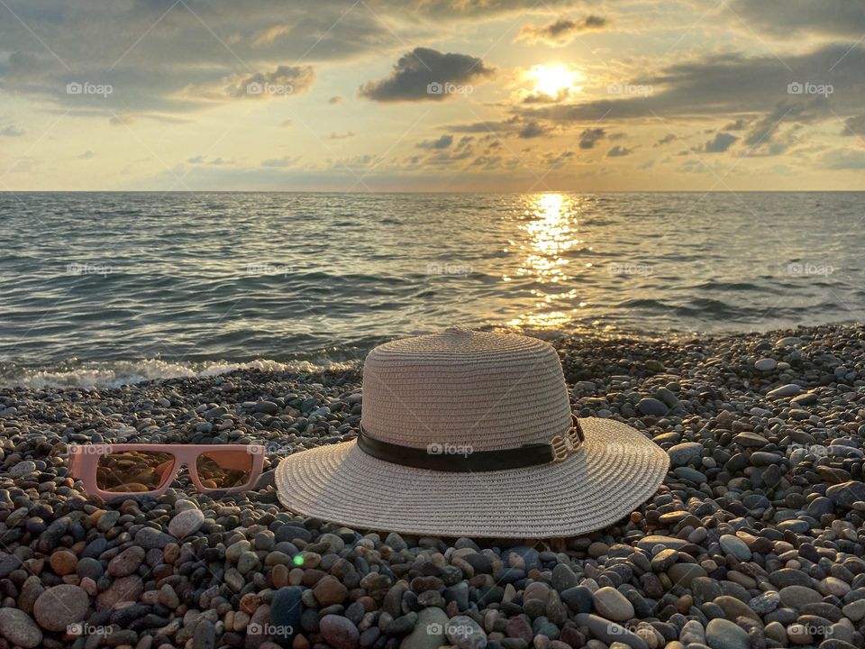 sun hat and sunglasses on the beach