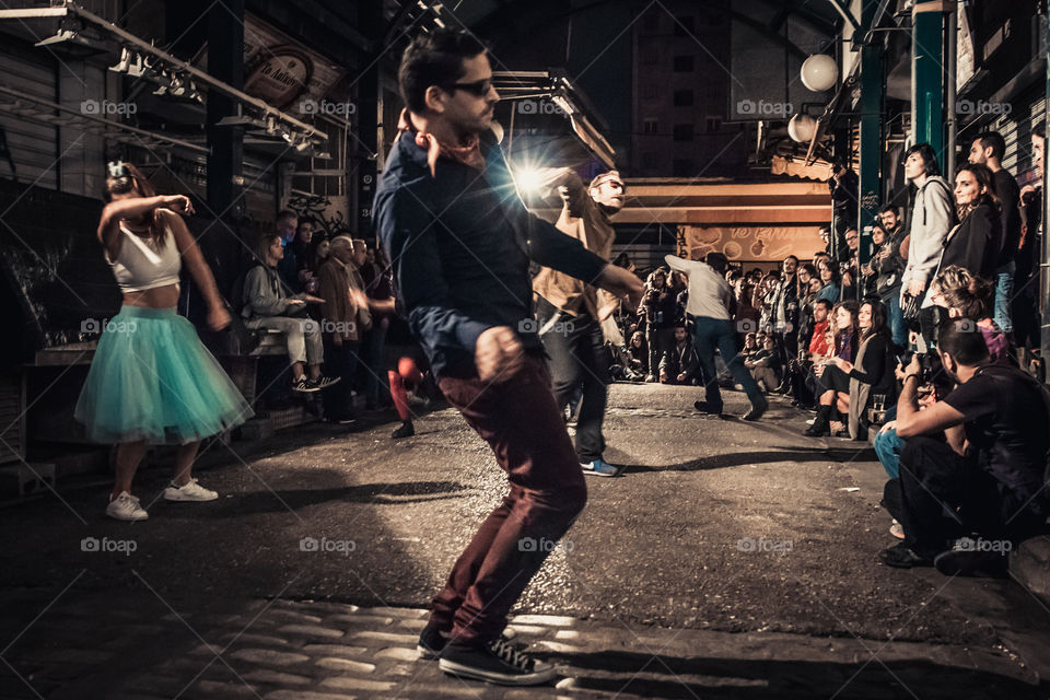 Street Dancing In The Night With Crowd Of People Watching
