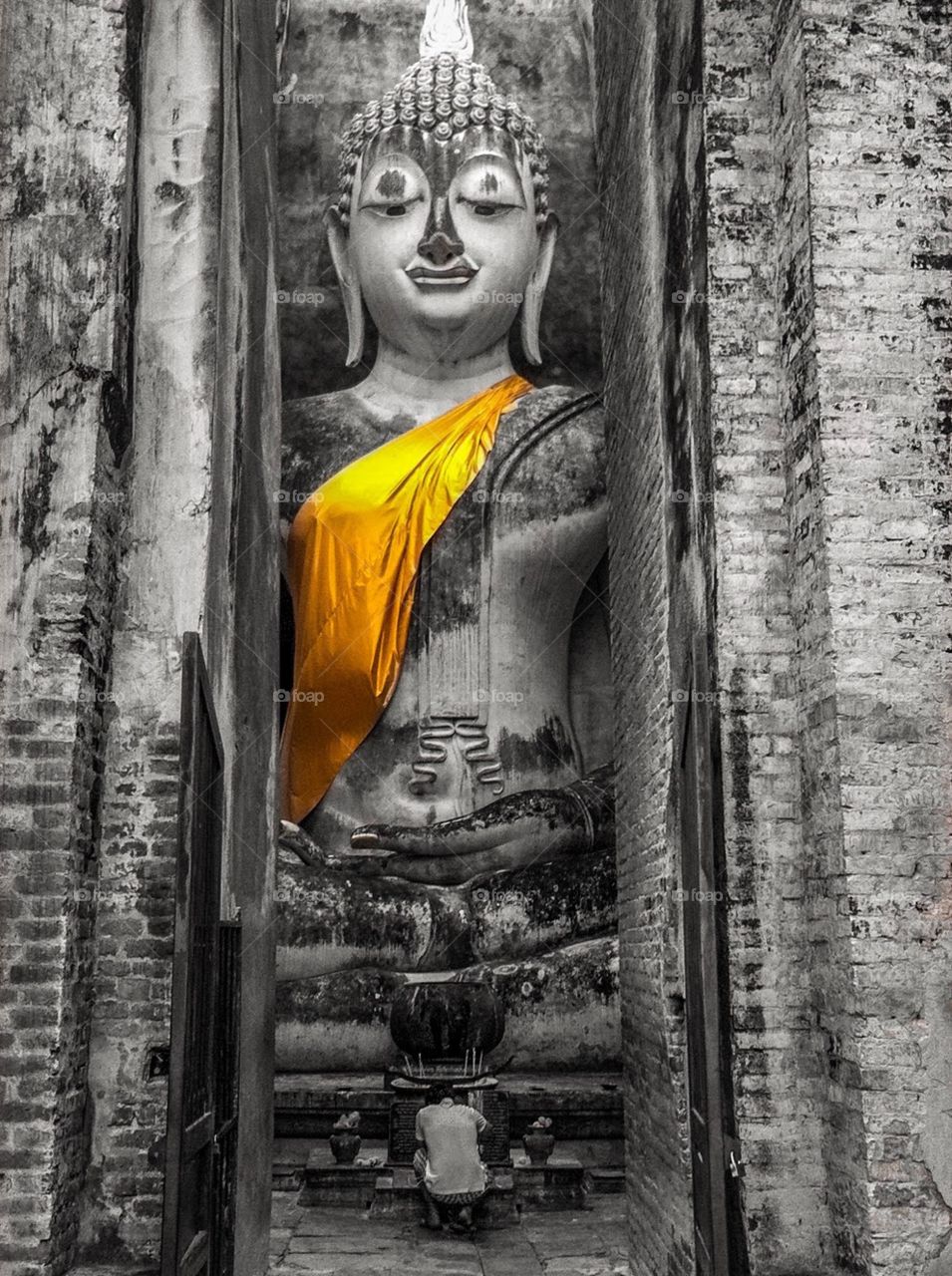 A man pray in front of Thai famous Buddha