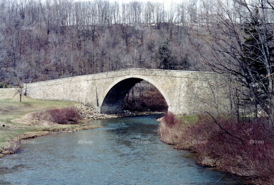 old stone bridge. old stone arch bridge over river in rural countryside