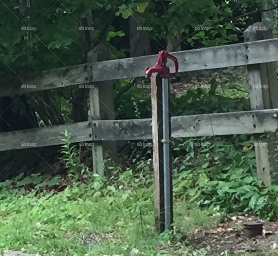Red pump and fence