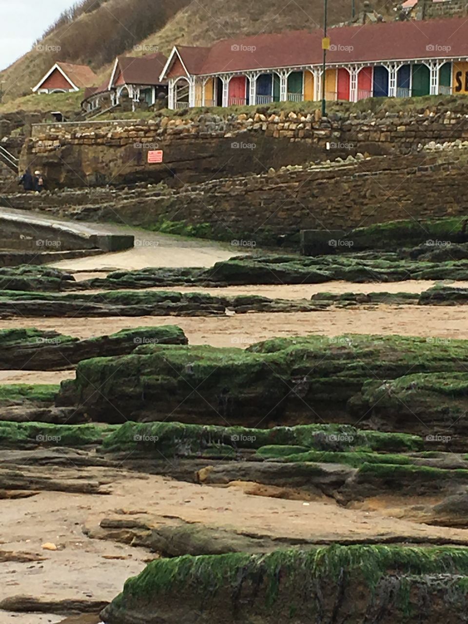 Scarborough beach at low tide , beach huts on the horizon 