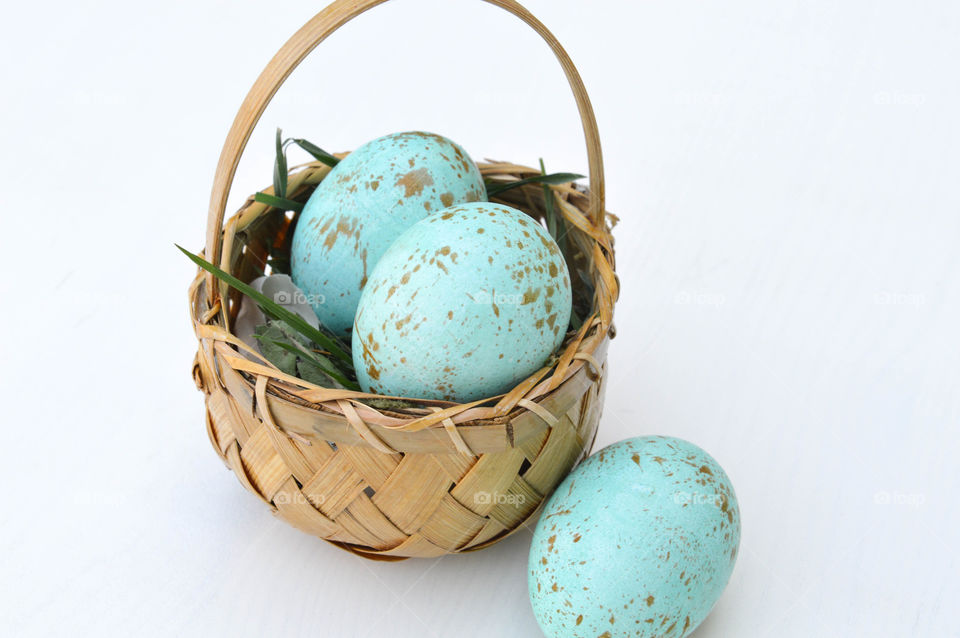 Tiny Easter basket with blue colored robin eggs