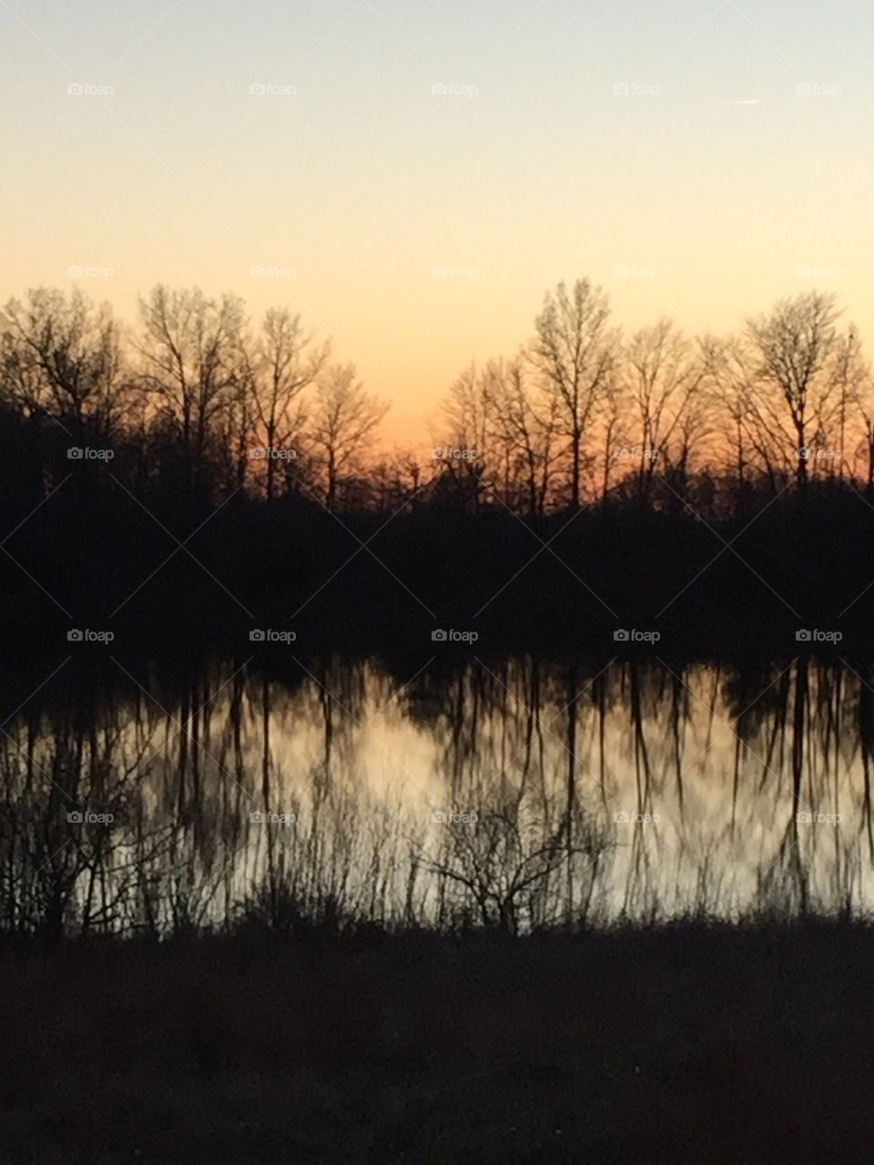 Sunset reflection on lake in the Midwest, Indiana winter