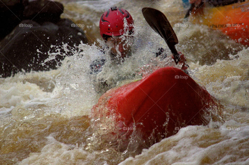 Helsinki, Finland -  April 17, 2016: Unidentified racer at the annual iceBREAK whitewater kayaking competition at the Vanhankaupunginkoski rapids in Helsinki, Finland. 