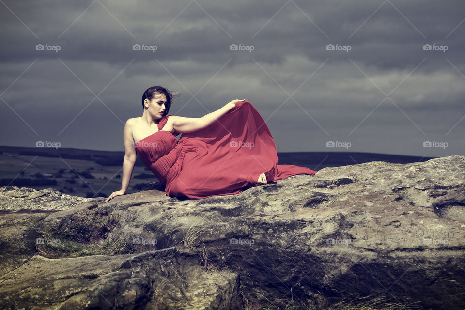 Young woman sitting on rock