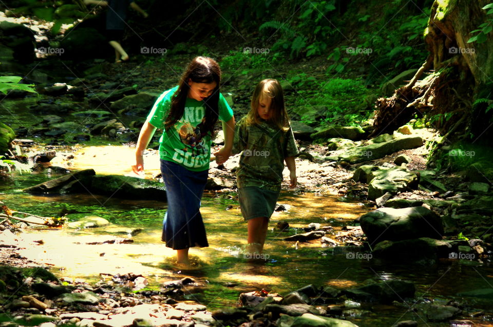 Gret & Grace. Gretchen (7) helping her sister Gracetyn (3) while walking in the creek