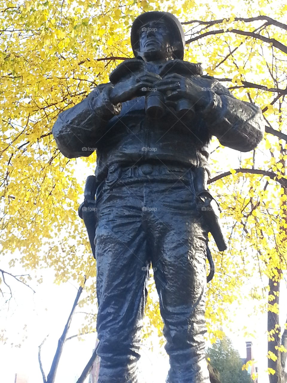 Fall in a Boston park. A statue seemed illuminated by the bright leaves