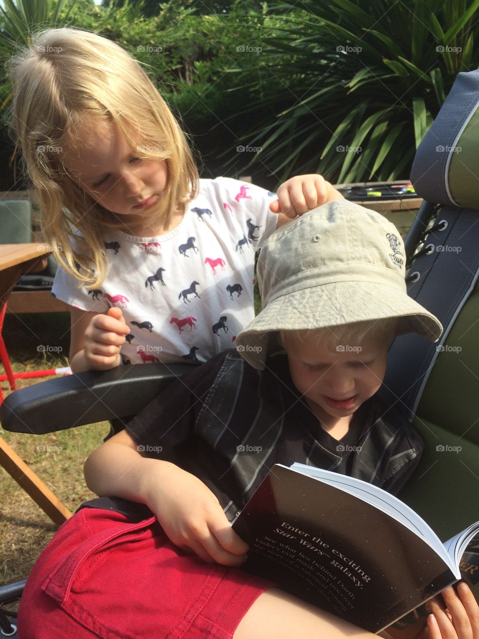 Reading Star Wars in the garden, Chertsey, Surrey, England.