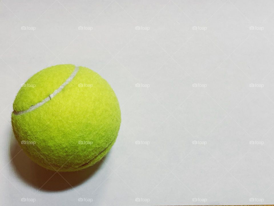 One tennis ball in a white background